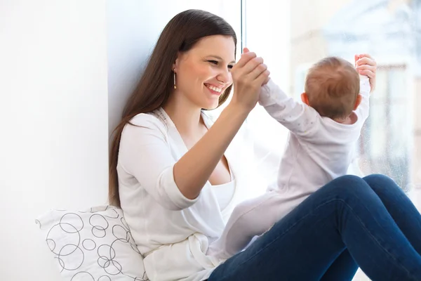Mother and Baby on the windowsill — Stock Photo, Image