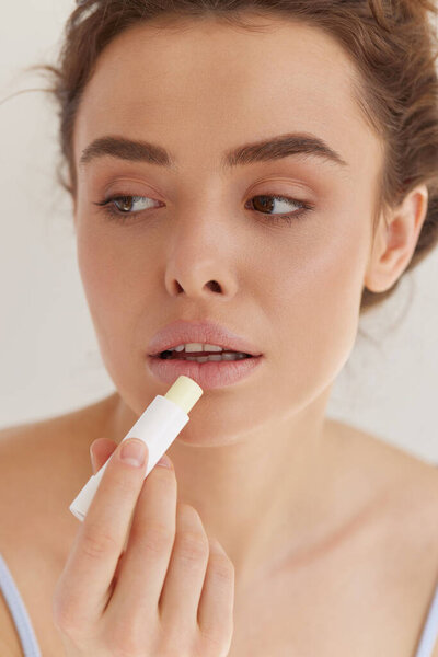 Lips Care Pretty Young Woman Brown Hair Applying Lipstick Moisturizing Royalty Free Stock Photos