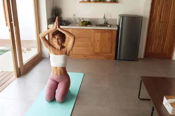 Yoga At Home. Woman In Easy Pose Warming Up Before Exercising. Young Female Sitting On Floor And Going To Practice. Sport Routine For Staying Calm