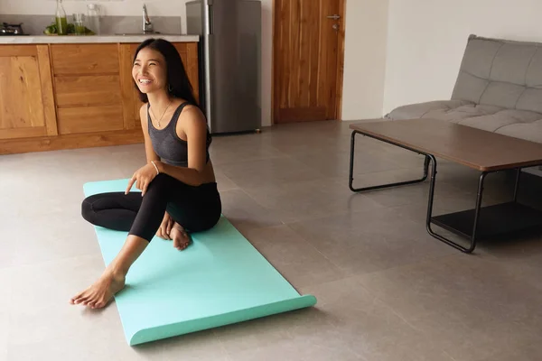 Yoga At Home. Asian Woman Relaxing Up Before Exercising. Young Female Sitting On Floor And Going To Practice. Sport Routine For Staying Calm