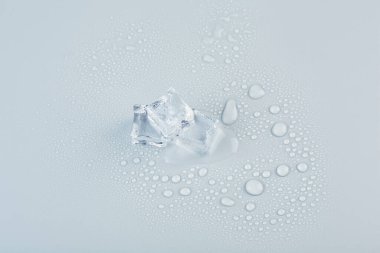 Three cold ice cubes folded by a pyramid, photo taken from above