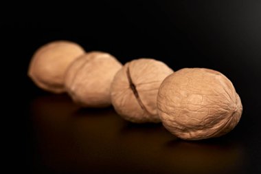 Walnuts on a black background in the shell close-up