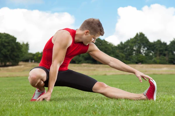 Stretching out in a park — Stock Photo, Image