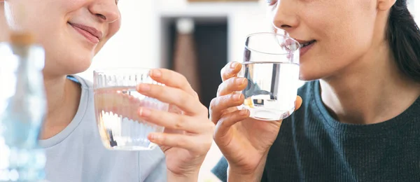 friends drinking a fresh glass of water at home