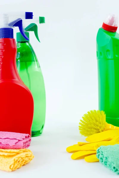 Colorful cleaning set for different surfaces in kitchen, bathroom and other rooms. Empty place for text or logo on isolated background. Cleaning service concept. Early spring regular clean up.