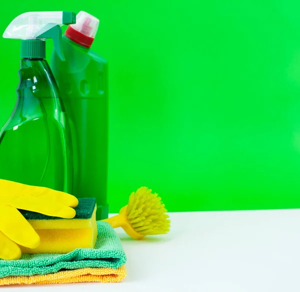 Colorful cleaning set for different surfaces in kitchen, bathroom and other rooms. Empty place for text or logo on isolated background. Cleaning service concept. Early spring regular clean up.