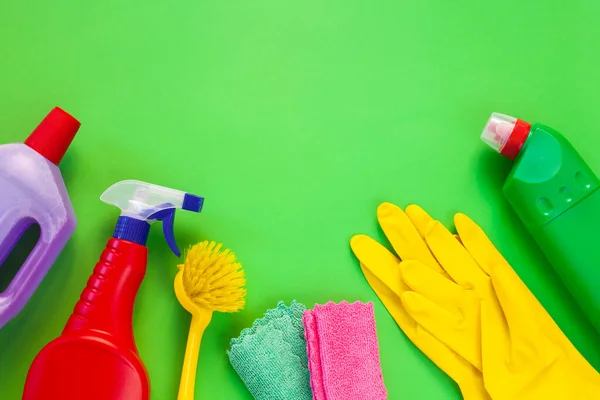 Colorful cleaning set for different surfaces in kitchen, bathroom and other rooms. Empty place for text or logo on isolated background. Cleaning service concept. Early spring regular clean up.