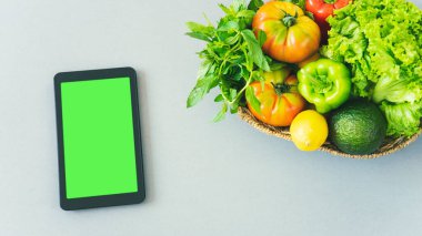 digital tablet with the eco bag and fresh vegetable. online grocery and organic farmer product shopping application. food and cooking recipe or nutrition counting.flat lay.