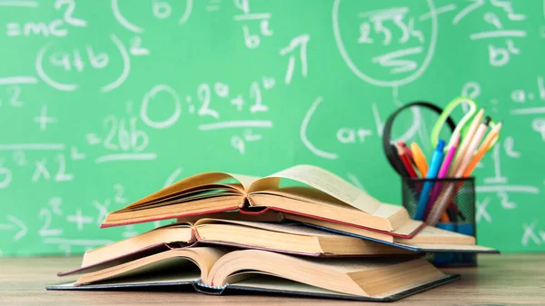 School books and pencils on desk, education concept