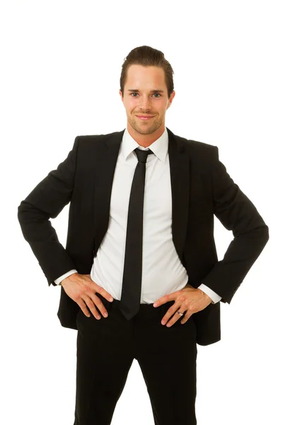 Hombre de negocios sonriendo con las manos en las caderas — Foto de Stock