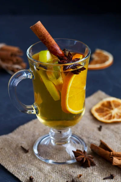 Fotokopi odasıyla sıcak içecek. Noel sıcak beyaz şarabı portakal, bal, tarçın çubukları ve siyah arka planda baharat ve malzemelerle dolu yıldız anason. Baharatlı sıcak içecek..