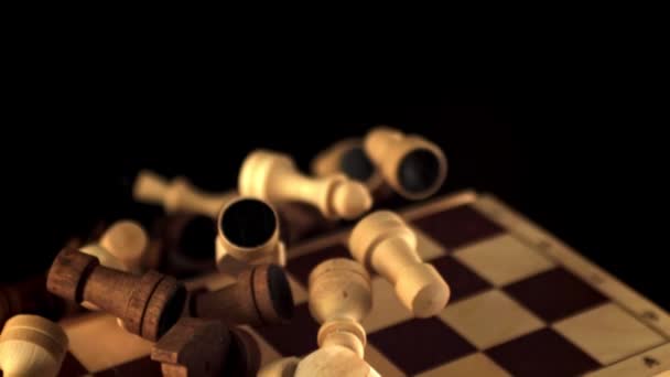 Super slow motion chessboard with pieces takes off and falls down. Filmed on a high-speed camera at 1000 fps. — Stock Video