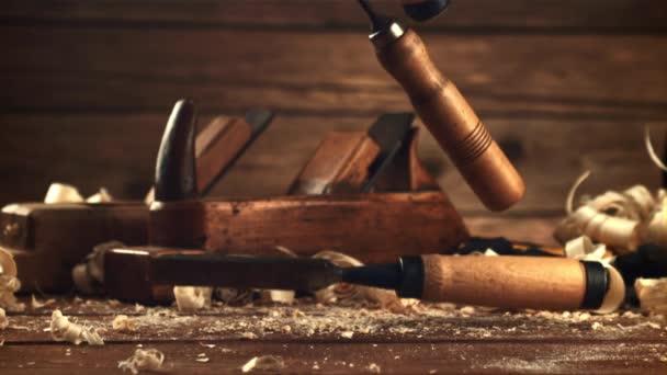 Chisels fall on a table of sawdust. Filmed is slow motion 1000 frames per second. — Video Stock