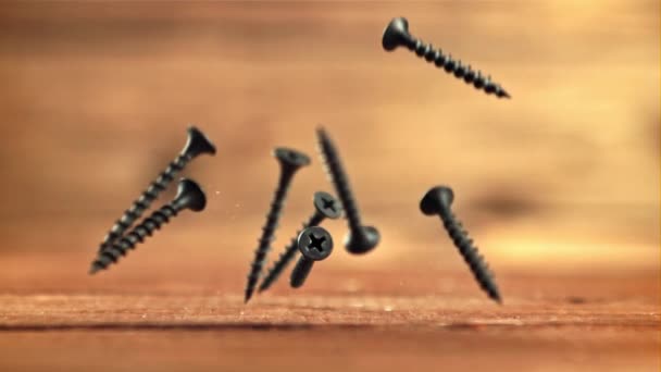 A bunch of self-tapping screws fall on the table. Filmed is slow motion 1000 fps. — Stock Video