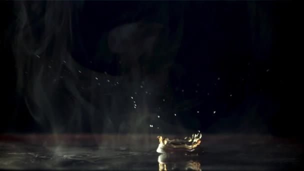 A drop falls into black coffee with hot steam. Filmed is slow motion 1000 frames per second. — Vídeo de Stock