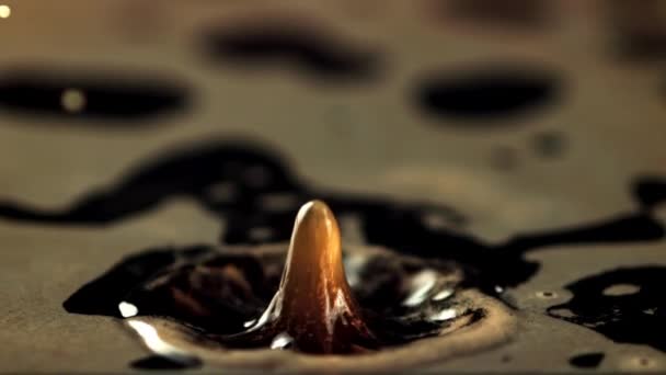 A drop of spray falls into the black coffee. Macro background.Filmed is slow motion 1000 frames per second. — Wideo stockowe