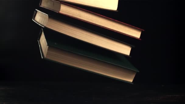 Books fall on the table. Filmed is slow motion 1000 fps. — Vídeos de Stock