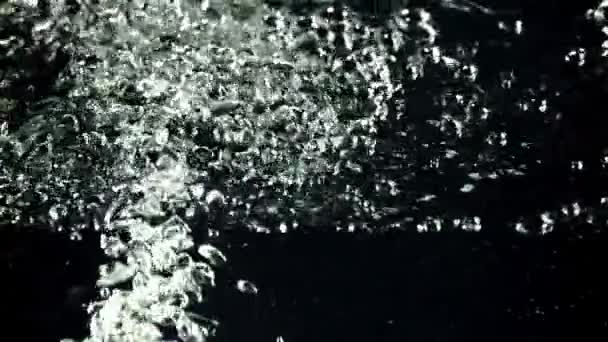 A jet of air bubbles under water rises upwards. Filmed is slow motion 1000 fps. — Stockvideo
