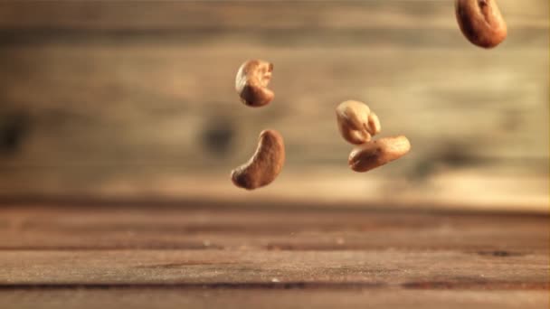 Cashew nuts fall on the table. Filmed is slow motion 1000 frames per second. — Videoclip de stoc