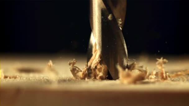 Drill wood with sawdust. Filmed is slow motion 1000 fps. — Video