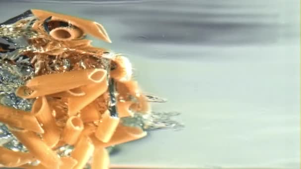 De pasta valt in het water met luchtbellen. Gefilmd op een hoge snelheidscamera met 1000 fps. — Stockvideo