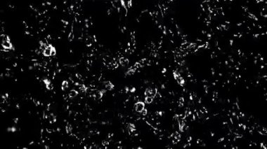 Su damlacıkları uçuşta döner. Üst Manzara. Siyah bir arka planda. 1000 fps hızla yüksek hızlı bir kamerayla çekildi..