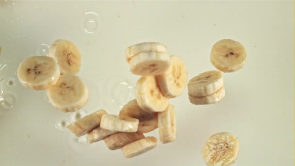 Pieces Fresh Bananas Fall Milk Splashes Macro Background Filmed High — Stock Video