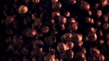 Bir grup fındık yukarı çıkar ve aşağı düşer. Üst Manzara. Fındık deseni. Film yavaş çekimde 1000 fp..