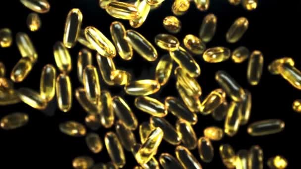 Omega Vitaminecapsules Roteren Langzaam Tijdens Vlucht Een Zwarte Achtergrond Gefilmd — Stockvideo