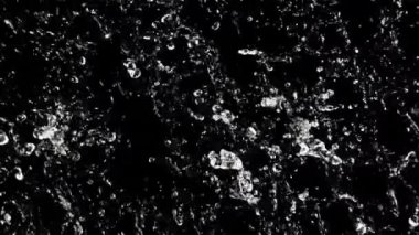 Uçan suyun hareketi. Üst Manzara. Siyah bir arka planda. Film yavaş çekimde 1000 fp..