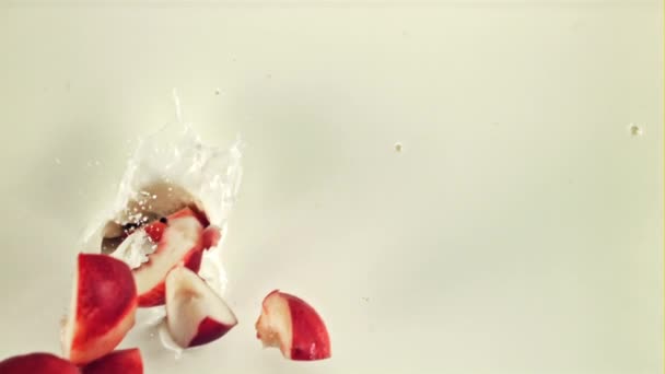 Sliced Fresh Peach Splashes Falls Milk Top View White Background — Stock Video