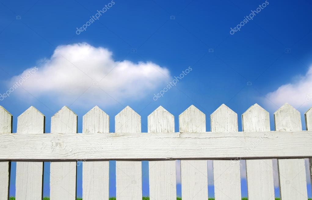 grass and white picket fence