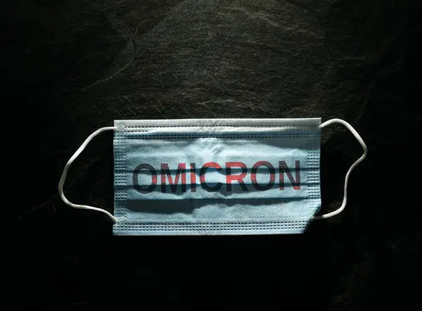 Blue Surgical Face Mask Omicron Text Dark Background Covid Ppe — 图库照片