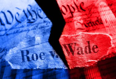 Torn Roe V Wade newspaper headline in red and blue on the US Constitution with the United States Supreme Court in background                               