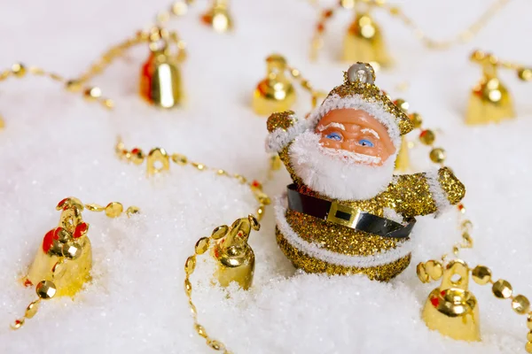 Santa Claus figurine and Christmas golden bells — Stock Photo, Image