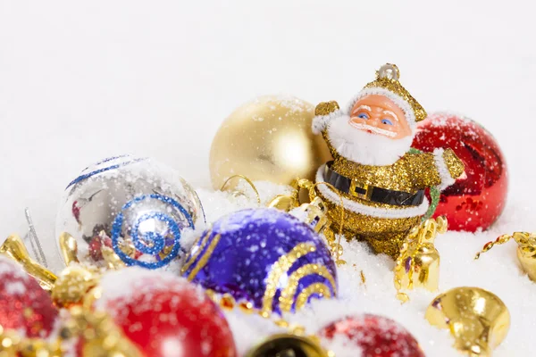 Santa Claus figurine and Christmas balls — Stock Photo, Image