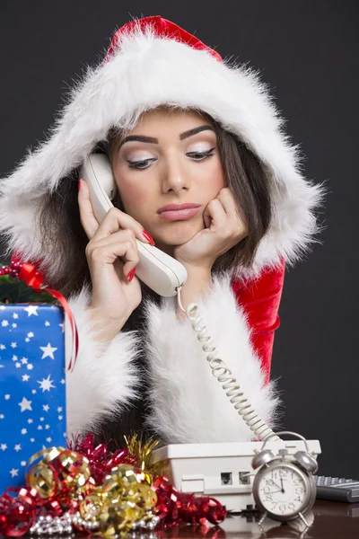 Unhappy Santa girl on the phone — Stock Photo, Image