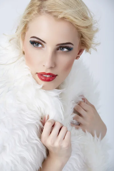 Stylish blonde woman posing in white fur — Stock Photo, Image