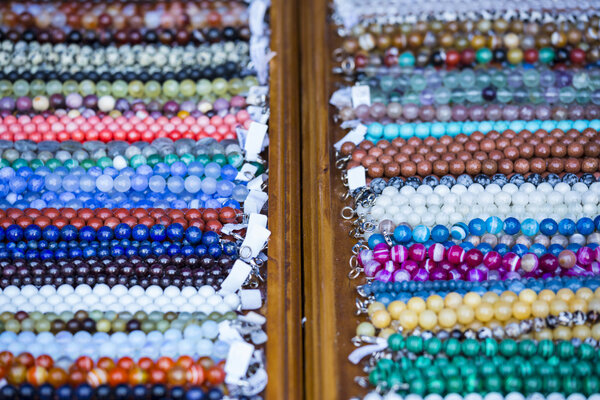 Wooden shelf with colorful necklaces