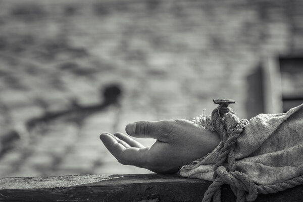 Nailed hand on wooden cross