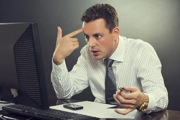 Desperate businessman pointing his finger to his head — Stock Photo, Image