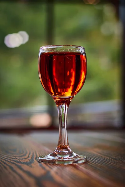 Glass of cognac on wooden table. Shot glass. — Stock Photo, Image
