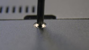 El yapımı bir zanaatkar tornavidayla vidayı sıkar..