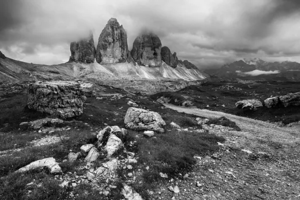 Black and white photo of Tre Cime at cloudy evening — Stock Photo, Image