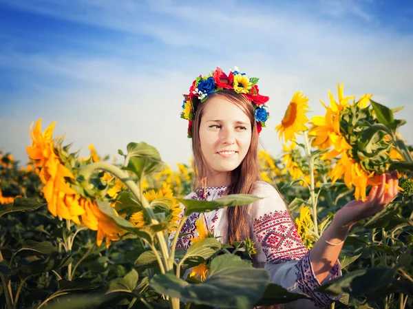 Mooie jonge vrouw op zonnebloem field — Stockfoto