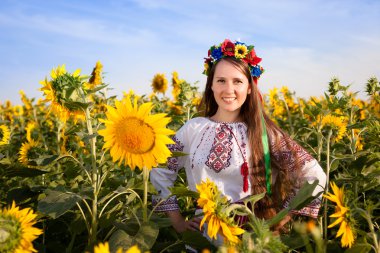 Beautiful young woman at sunflower field clipart