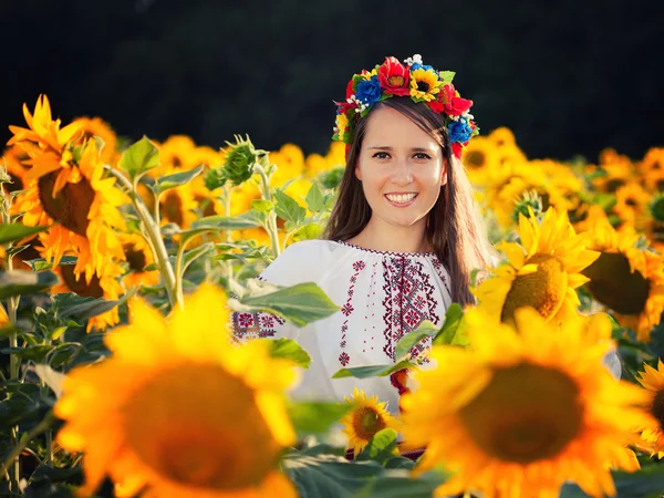 Mooie jonge meisje op zonnebloem veld — Stockfoto