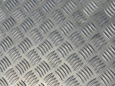 Elmas şekilli metal arka plan, pürüzsüz desenli ağır metal dokunun etrafına sarılmış..