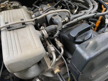 Oto servis endüstrisinde ve araçlarda araç bakımı sırasında birinci sınıf bir aracın motor bölmesine monte edilmiş turuncu şasili bir motor için kirli hava filtresinde yakın çekim.