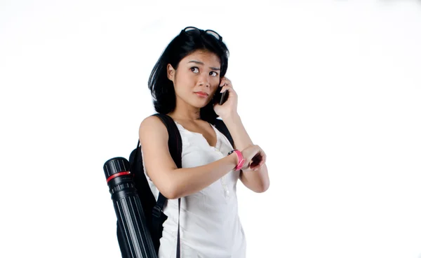 Girl using mobilephone and waiting for someone on white background — Stock Photo, Image